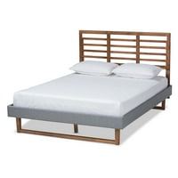 Moderni krevet s platformom veličine MPN-a presvučen je tamno sivom tkaninom i završnom obradom od jasena, oraha